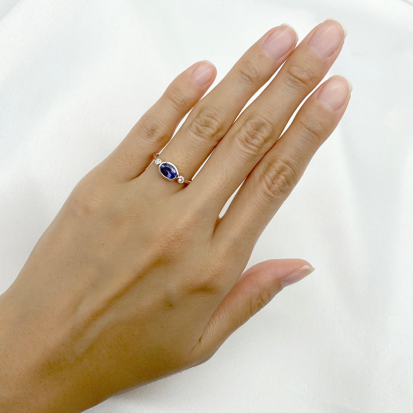 14K OVAL TANZANITE DIAMOND BEZEL RING