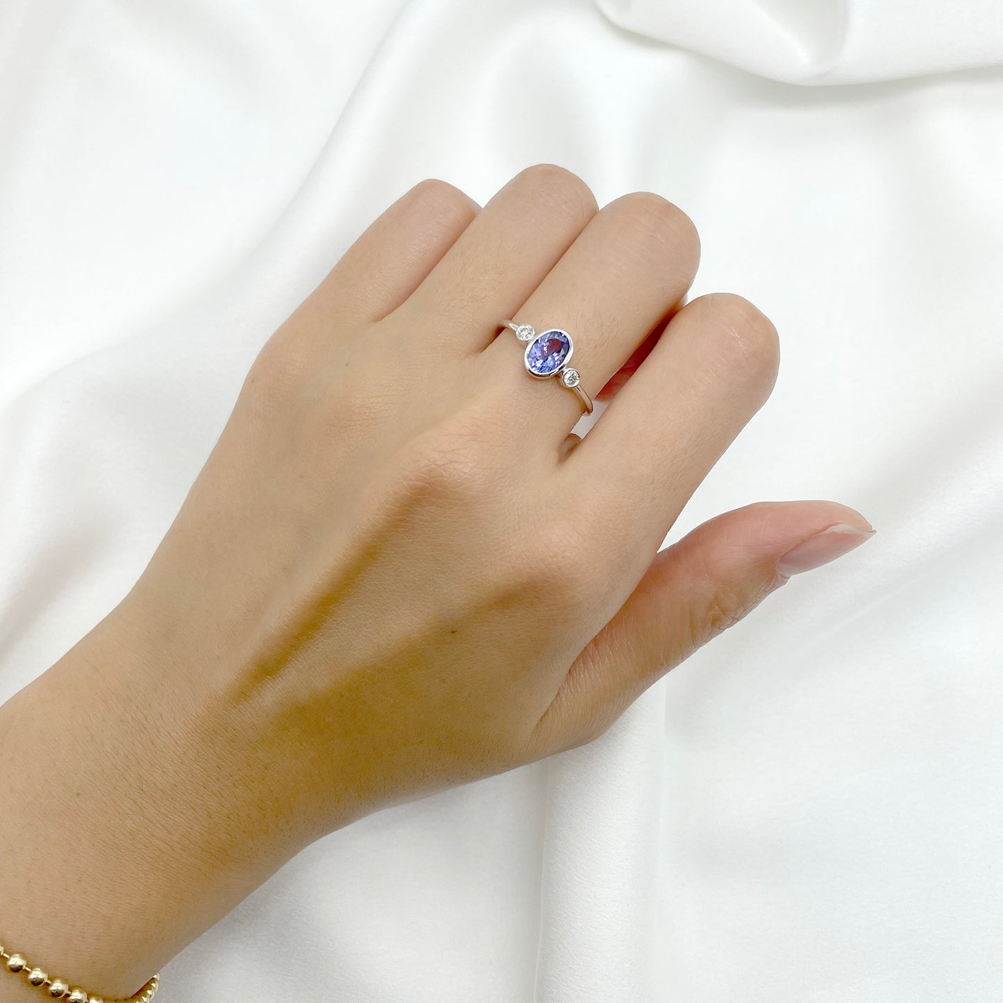 14K OVAL TANZANITE DIAMOND BEZEL RING