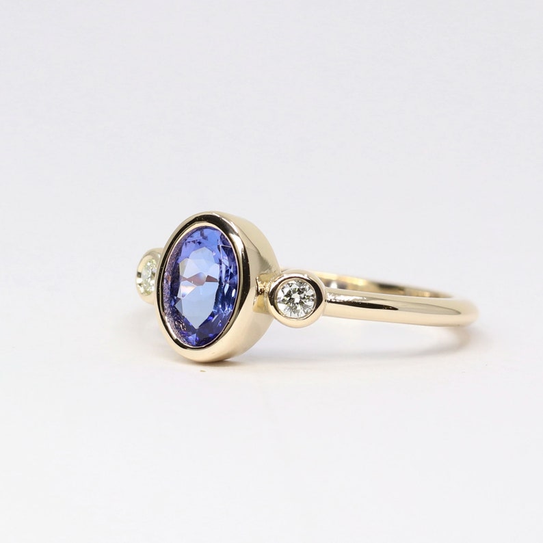 14K OVAL TANZANITE DIAMOND BEZEL RING