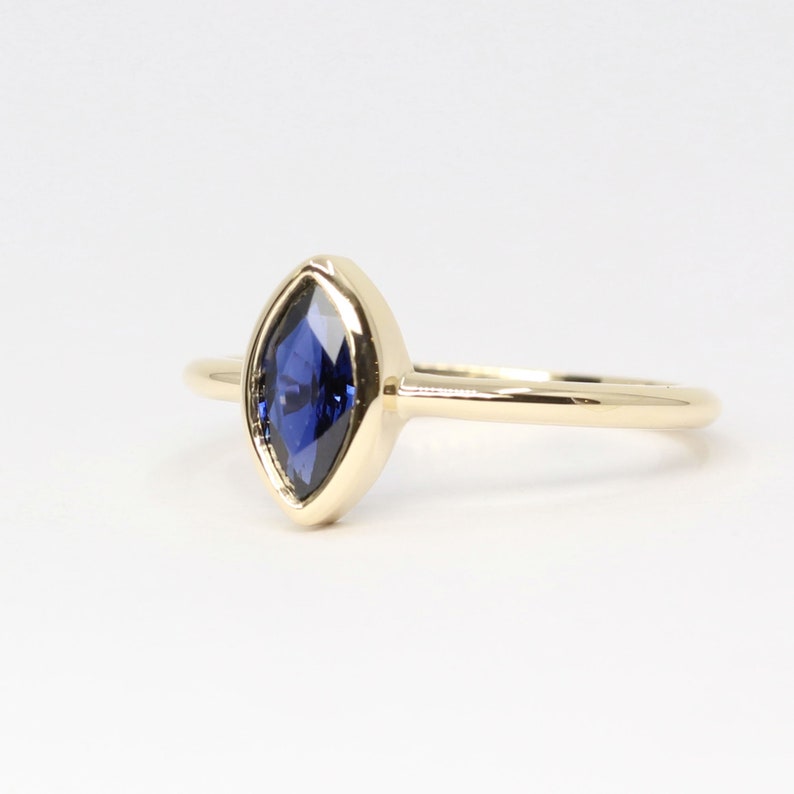 14K MARQUISE SAPPHIRE BEZEL SOLITAIRE RING